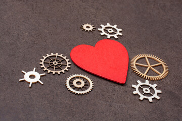 Gear wheels on red Heart shape. Valentine concept and promise of love.