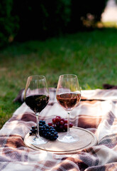 Wine in glasses with bunch of grape on wooden table