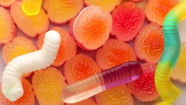 gelatin in the form of brains and worms, rotation in a circle. Halloween background. brain jelly, rotating. selective focus.  