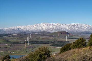 View of Mount Hermon and the countryside with windmills and ponds in northern Israel from Mount...
