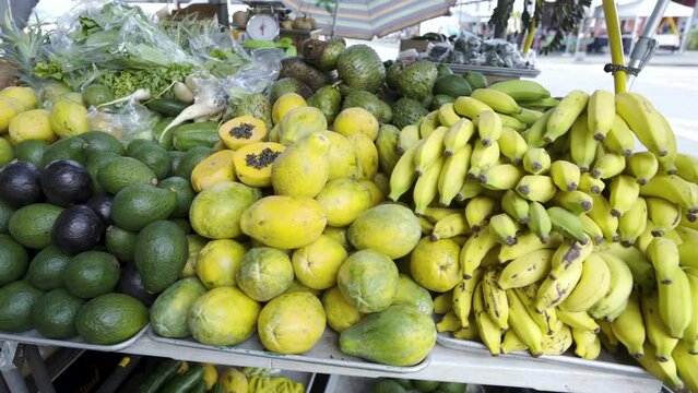 Cinematic gimbal shot of fruits stand at Farmer's Market in Hilo in Hawaii Island, USA