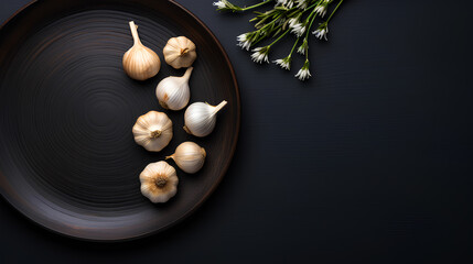 Obraz na płótnie Canvas bowl of garlic on black background