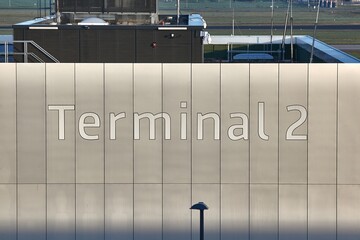 Terminal 2 sign on airport terminal wall