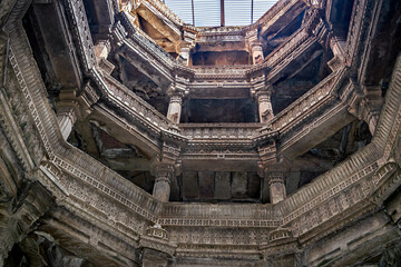 Intricate carvings and blue sky inside heritage structure of Adlaj step-well also known as Rudabai...