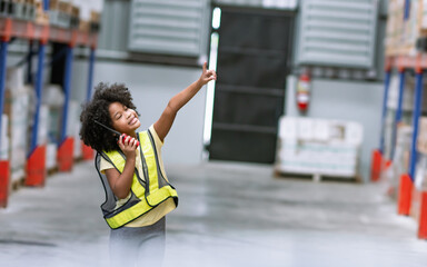 Little african afro hair girl wearing casual shirt, playing with happiness in warehouse or factory...