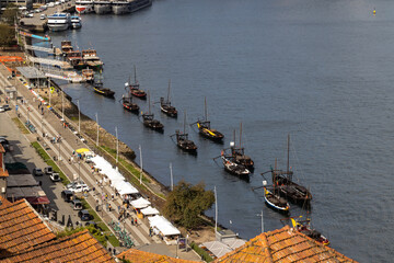 The city of Porto in Portugal, the Douro river, boats, the metal Luis Bridge