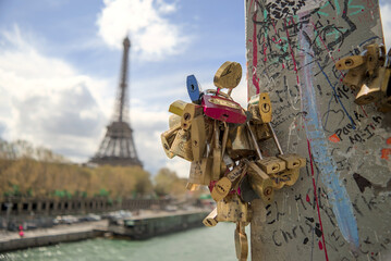 Paris, France - April 3 2019: Love locks or padlocks as love symbols close to the Eiffel Tower, Paris