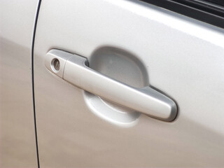 close-up of gray car door handle.