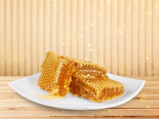 Tasty sweet Honeycomb with syrup on plate