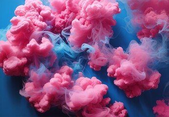 Puffs of pink smoke in front of a blue background 