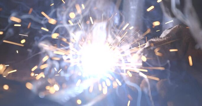 Welding of metal structures with sparks flying in the air.