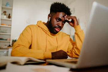 African american businessman is having a boring conference call with a team.
