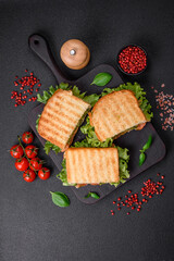 Delicious crispy sandwich with toast, salmon, avocado, tomatoes, salt, spices and herbs