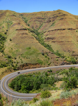 A car making the turn on a curvy section of Highway 129 in Eastern Washington near the Oregon border; Clarkston, Washington, United States of America