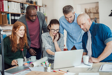 Group of people working together on a project in a startup company office
