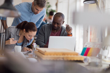 Group of people working together on a project in a startup company office