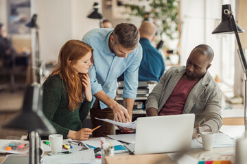 Group of people working together on a project in a startup company office