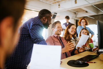 Diverse group of coworkers working together on a project in the office of a startup company