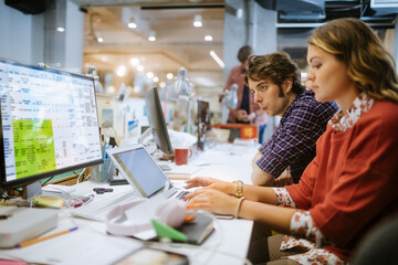 Diverse group of young office workers working together in a startup company in a modern business office