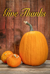 Give Thanks - a greeting card with a pumpkin and hubbard winter squash against rustic barn wood