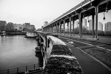 Long row of metal columns of elevated subway. Bir Hakeim Bridge in Paris, France. Black and white image.