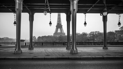 Eiffel Tower view from Bir Hakeim Bridge on sunny morning. Paris, France. Black and white image.
