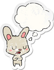 cartoon rabbit talking with thought bubble as a distressed worn sticker