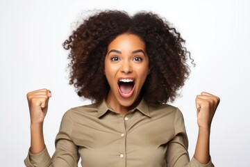 A woman with a voluminous afro hairstyle expressing excitement. This image can be used to depict joy, enthusiasm, happiness, or celebration.