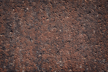 Surface texture of a brown concrete slab.