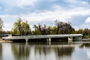 Pedestrian bridge in Bordei park over the lake. Bucharest, Romania.