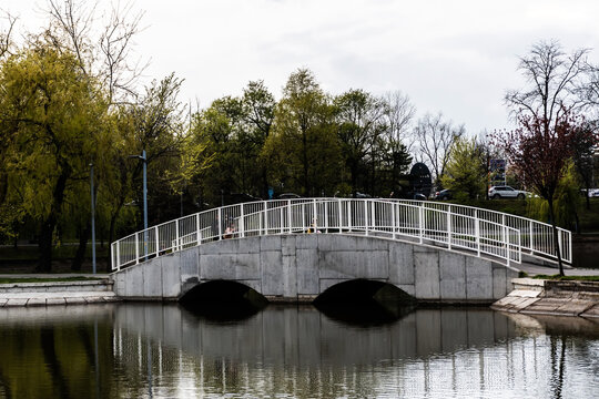 Pedestrian bridge in Bordei park over the lake. Bucharest, Romania.