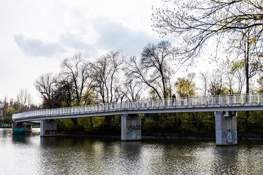 Pedestrian bridge in Bordei park over the lake. Bucharest, Romania.
