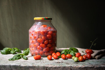 red and yellow cherry tomatoes in a jar for winter