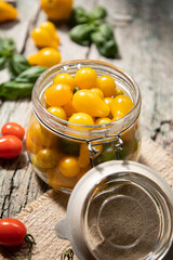 red and yellow cherry tomatoes in a jar for winter