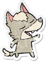 distressed sticker of a cartoon wolf laughing