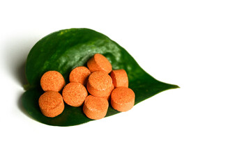 Vitamin-C tablets with white background.