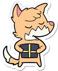 sticker of a friendly cartoon fox with christmas present