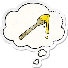 cartoon spoonful of honey with thought bubble as a distressed worn sticker