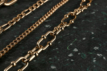 Beautiful chain bracelets and necklace on black background