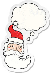 cartoon santa face with thought bubble as a distressed worn sticker