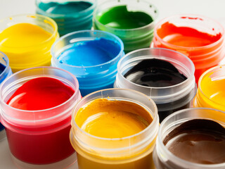 Jars of acrylic gouache paint art painting creativity and development close-up