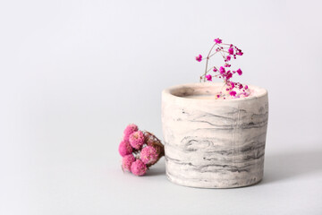 Holder with candle and flowers on white background