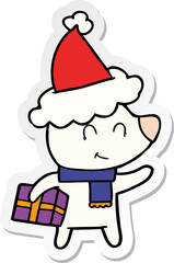 female polar bear with christmas present wearing santa hat