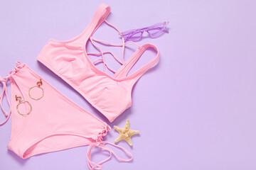 Stylish swimsuit, sunglasses, earrings and starfish on color background