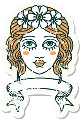 worn old sticker with banner of female face with crown of flowers