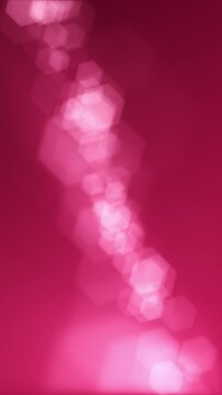 Vertical video - defocused bokeh lights background. This elegant magenta motion background animation with hexagonal lens blur bokeh particles is full HD and a seamless loop.
