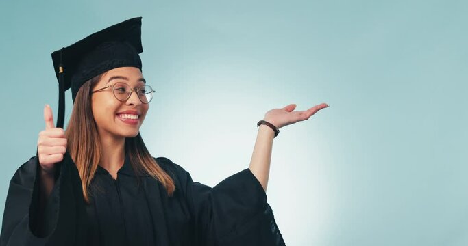 Happy woman, student and palm with thumbs up for graduation success against a studio background. Portrait of female person or graduate with hand out, like emoji or yes sign for thank you or winning