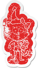 quirky cartoon distressed sticker of a cat wearing santa hat