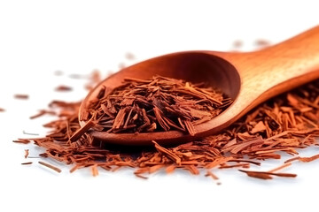Heap of dry rooibos tea leaves with wooden scoop, closeup view