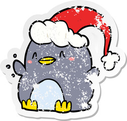 distressed sticker of a cartoon penguin wearing christmas hat